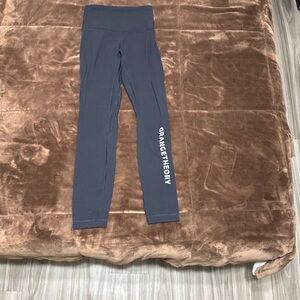 Woman’s size 4 Lululemon black leggings with orange theory logo.